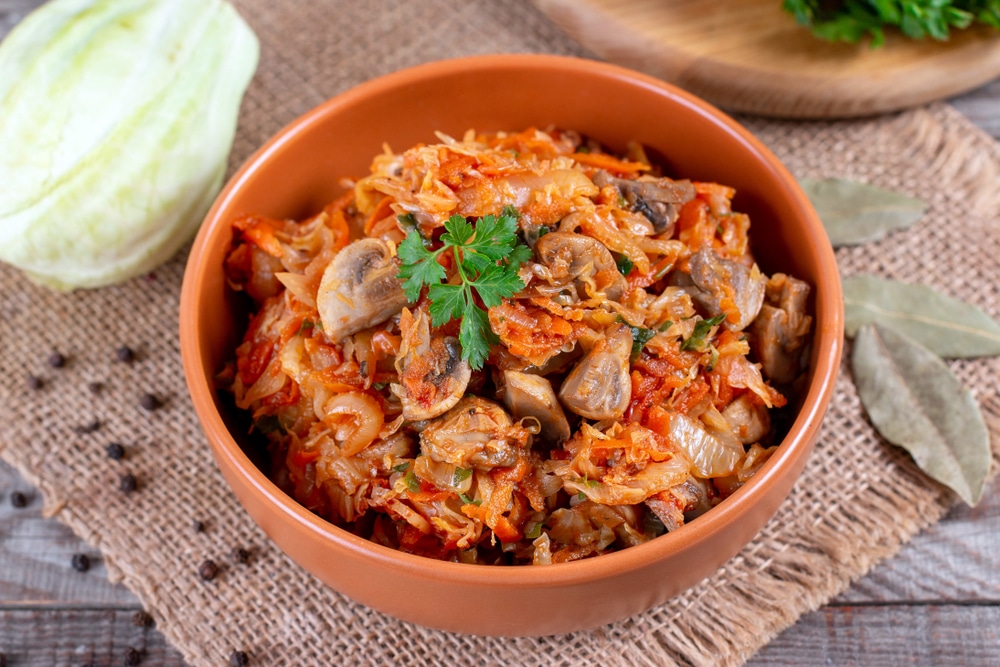 Cabbage stewed with sausages and mushrooms